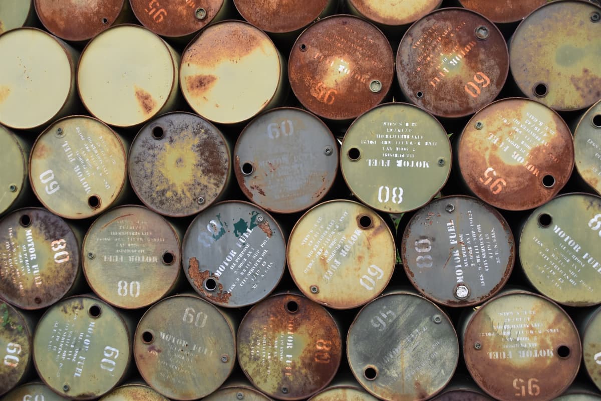 Rusted steel barrels stacked outdoors