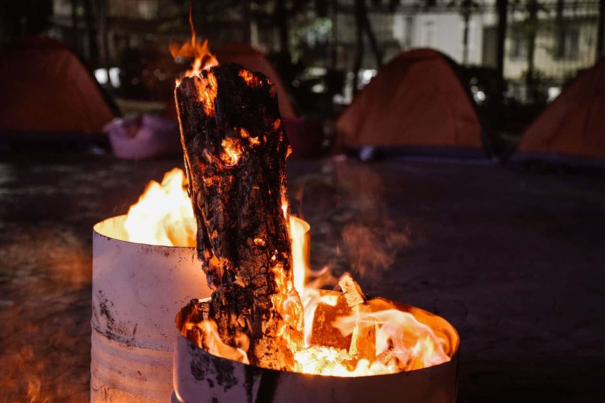 Tents lit by a campfire at night