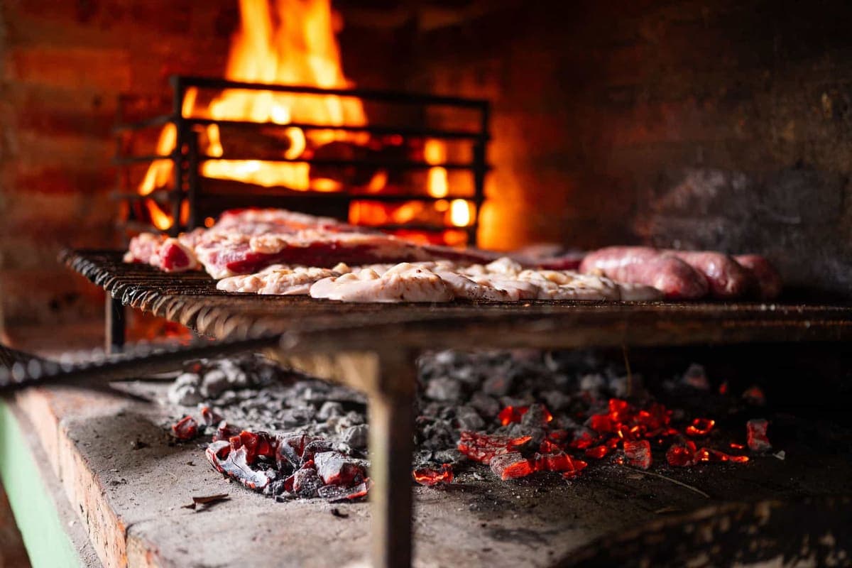 Glowing coals under a barbecue grill grate