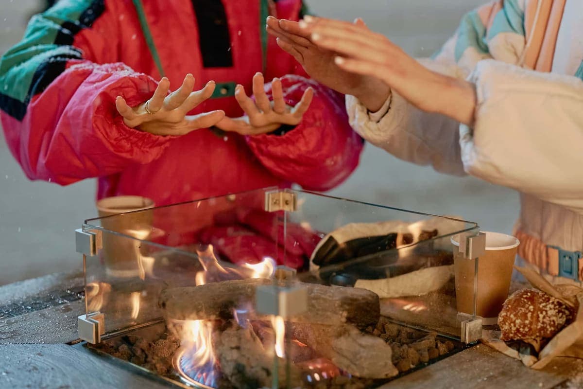 Hands held out to warm over a fire