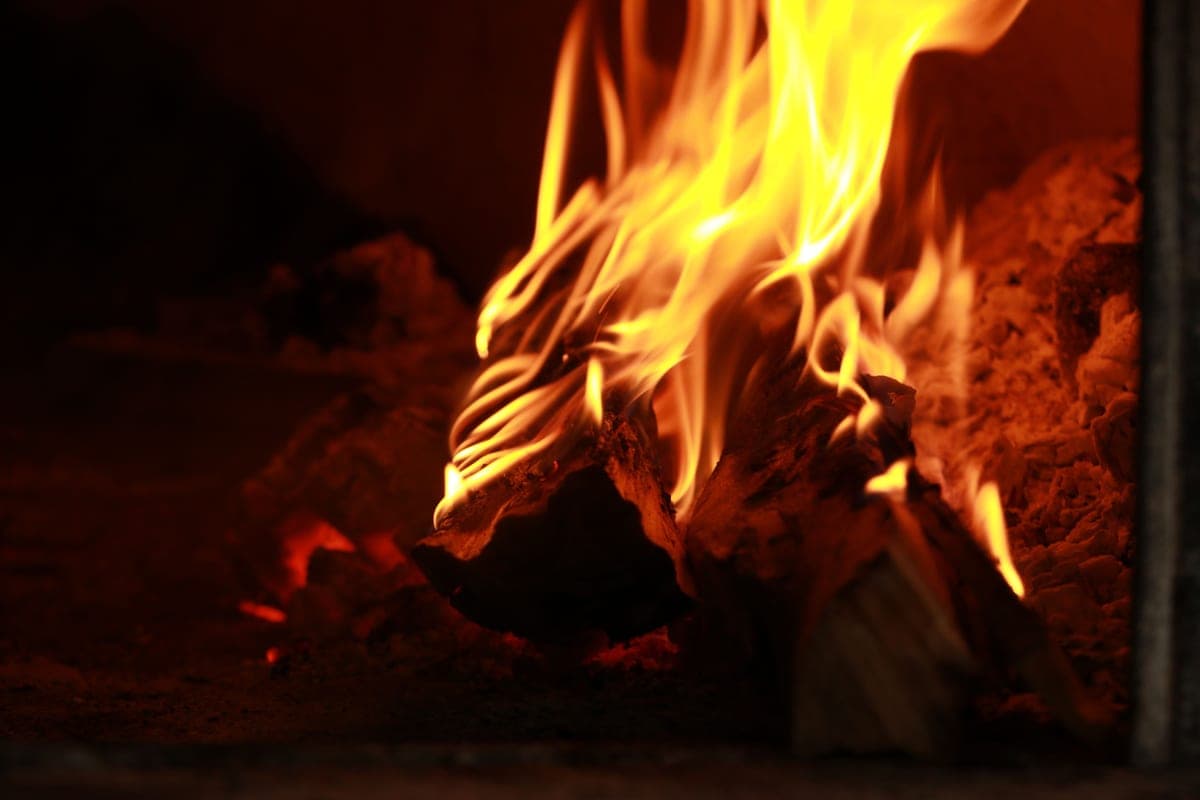 Small wood pieces burning in a compact fire