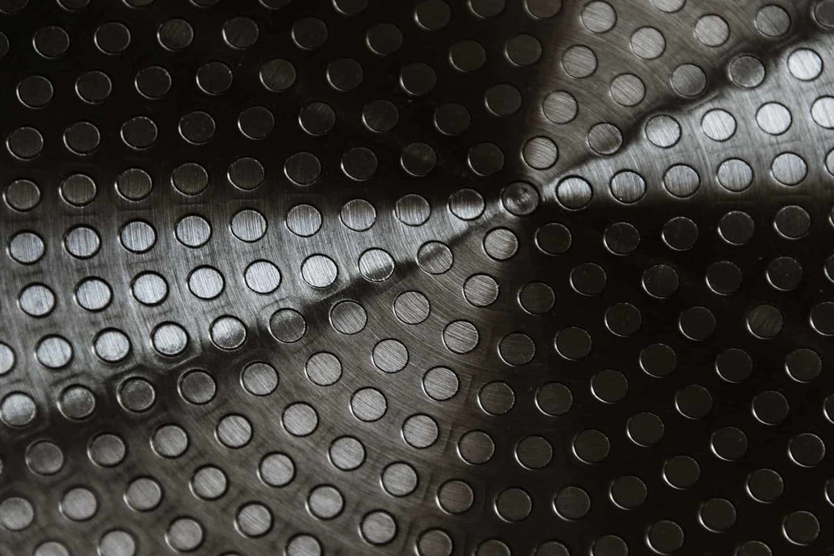 A brushed metal surface with a circular machined pattern